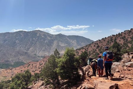 Toubkal Trek hikers ascending Mount Toubkal with panoramic High Atlas mountain views