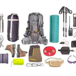 Essential Mt Toubkal trekking gear laid out, including hiking boots, layered clothing, backpack, trekking poles, and headlamp.
