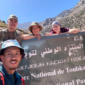 Local Amazigh mountain guide interacting with trekkers during the Morocco Mount Toubkal trek in the High Atlas Mountains Local Amazigh mountain guide interacting with trekkers during the Morocco Mount Toubkal trek in the High Atlas Mountains