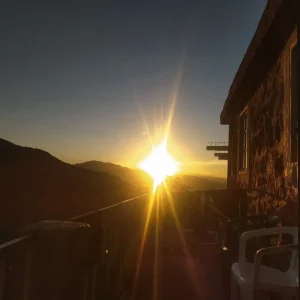 Early morning view of Imlil village with quiet rooftops, soft sunrise light, and the High Atlas mountains in the background. Early morning view of Imlil village with quiet rooftops, soft sunrise light, and the High Atlas mountains in the background.