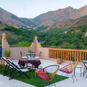 Panoramic golden-hour view of Imlil Valley showing terraced fields, walnut trees, and traditional stone houses under soft mountain light. Panoramic golden-hour view of Imlil Valley showing terraced fields, walnut trees, and traditional stone houses under soft mountain light.