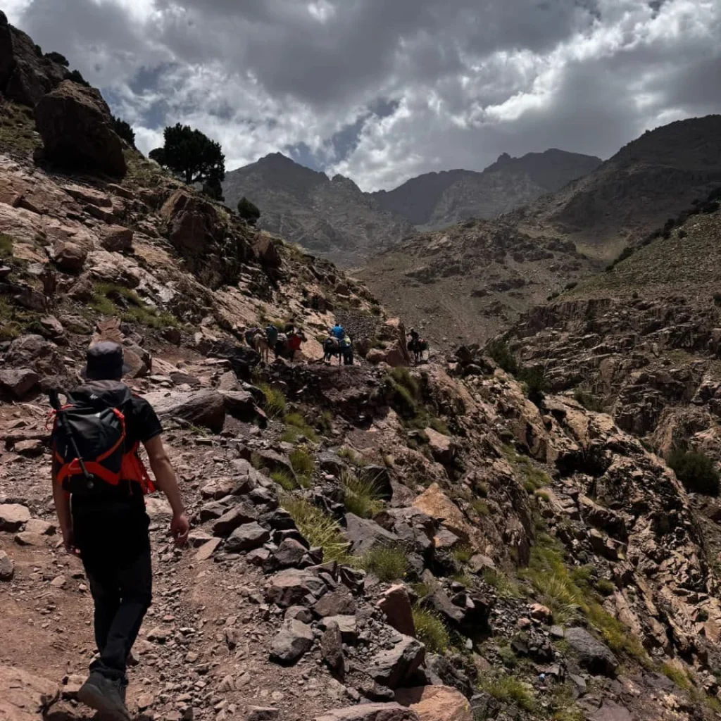 Local guide walking through the Atlas Mountains Morocco with traditional villages in the High Atlas