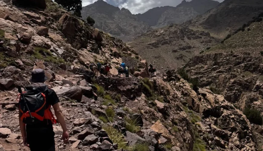 Local guide walking through the Atlas Mountains Morocco with traditional villages in the High Atlas