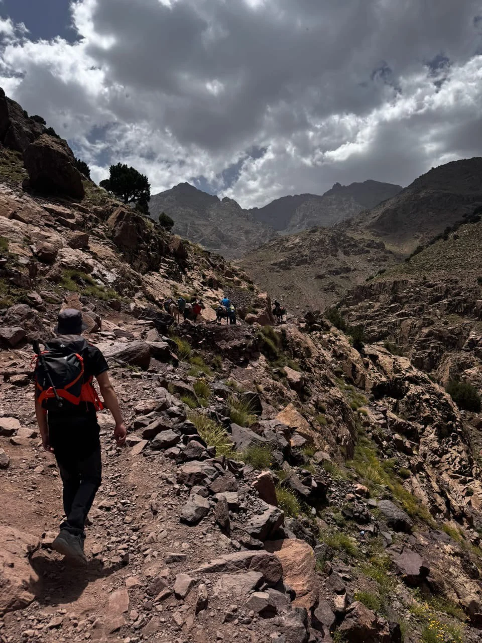 Local guide walking through the Atlas Mountains Morocco with traditional villages in the High Atlas