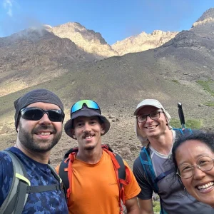 Mountain guide explaining the Toubkal route to hikers at Sidi Chamharouch, Morocco. Mountain guide explaining the Toubkal route to hikers at Sidi Chamharouch, Morocco.