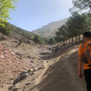 A local guide in the village of Imlil navigates the stone pathways within the Imlil valley. A local guide in the village of Imlil navigates the stone pathways within the Imlil valley.